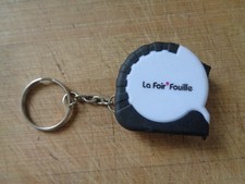 Porte clé avec mètre rétractable  " La Foire Fouille "