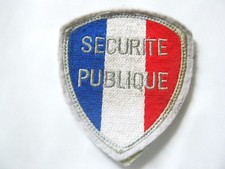 ECUSSON DE BRAS P.N / SECURITE PUBLIQUE SUR SCRATCH AU DOS BON ETAT GENERAL