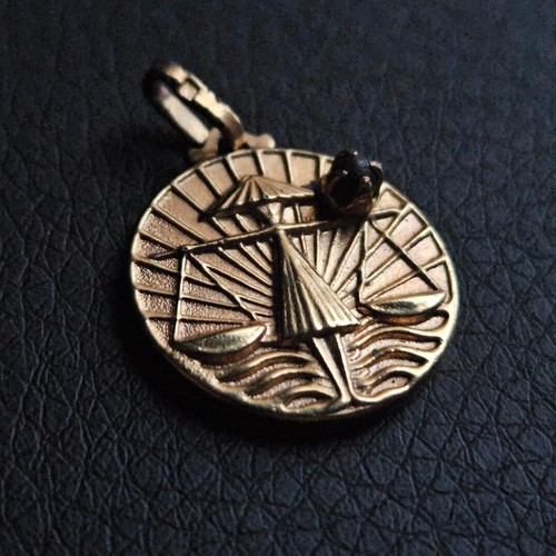 Médaille balance signe