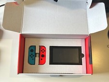 Nintendo Switch with Neon Blue and Neon Red Joy-Con and other accessories