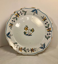 Assiette en faïence de Nevers. Décor de fleurs polychromes. Vers 1800.