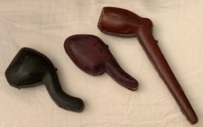 Three antique leather cased pipe boxes.