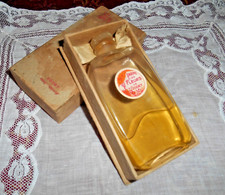 flacon de parfum parmi les fleurs de godet (étiquette en belle état)