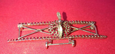 broche ancienne en forme d'avion à hélice, strass grenat et blanc