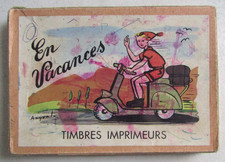 Ancienne boîte de 8 tampons encreurs ou "timbres imprimeurs" En Vacances ANYVAL