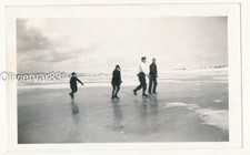 Vintage photo - 4 young men ice skating on a frozen lake Winter