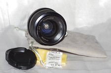 Objectif 28mm f2,8 UNITOR monture Exa avec bouchons avant-arrière et housse TBE