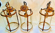 Suite de trois lanternes en bronze et verre de style louis XVI