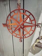Suspension murale rose des vents en métal verni aspect rouille,neuve 28x28cm