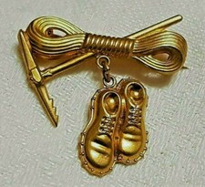 ANCIENNE BROCHE LAITON CORDE