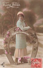 CP BONNE ANNEE FEMME BONNET POSANT AVEC GRAND FER CHEVAL DECORE DE ROSES