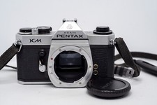 Reflex Argentique Asahi PENTAX KM 35mm + SANGLE/BOUCHON - LIRE/TEL QUEL!!!