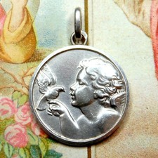 Child with a bird. Antique Silver Pendant. Large Medal by Contaux.
