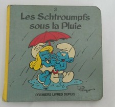 LIVRE BD LES SCHTROUMPFS SOUS LA PLUIE PREMIER LIVRE CARTONNE DUPUIS 1983