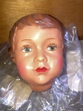 (h) tête de poupée