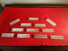 12 PORTE-COUTEAUX  EN METAL ARGENTE CHRISTOFLE MODELE ONDULATION  LUC LANEL