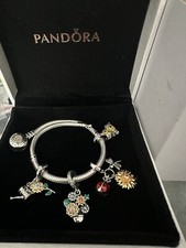 pandora bracelet Bicolor a 4 Charms Tournesols Valeur 579euros