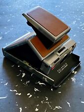 Polaroid SX-70 land camera deluxe marron. Avec sacoches, accessoires et papiers.