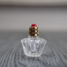 Miniature vide, bouteille en verre forme étoile décorée d'une perle