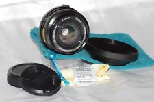 Objectif Olympus OM 28mm f2,8 VIVITAR avec bouchons, pare-soleil et housse TBE