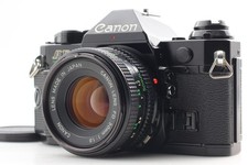 *Exc+5* Appareil photo argentique noir Canon AE-1 Program avec objectif NFD 5...