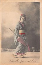 JAPAN - Geisha walking with a closed pink umbrella