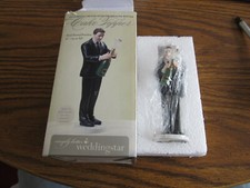 Groom popping champagne cake