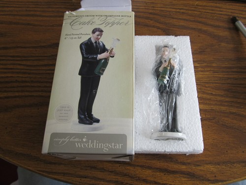 Groom popping champagne cake