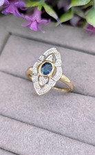 Bague marquise en 2 ors centré d'un saphir entouré de 10 petits diamants Or 750