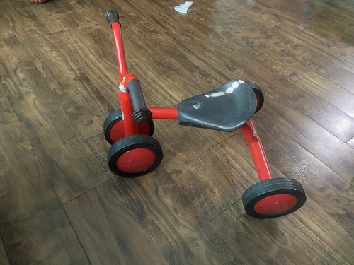 Red kids tricycle with - with, four