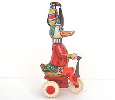 CANARD CLOWN PÉDALANT SUR TRICYCLE ANCIEN JOUET MÉCANIQUE WESTERN GERMANY
