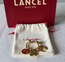Porte clés charms porte bonheur Lancel avec pochon et sac shopping.