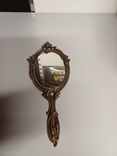 ancien miroir de sac face à