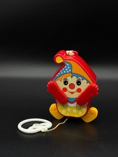 Jouet musical mécanique ancien clown peekaboo