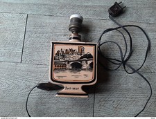 pied de lampe ancien paris pont neuf et décor stylisé avec tête de loup france 1