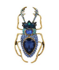 Broche Bijou insecte coléoptère style scarabée acier bronze et cristal bleu.