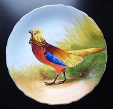 ASSIETTE en porcelaine de LIMOGES décor FAISAN DORÉ signé LUC