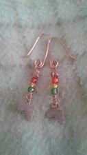 copper or silver colored Africa with red, gold and green bead earrings.