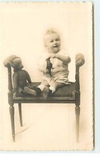 Toy baby sitting on - -,