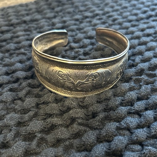 Silver toned metal bangle with - metal,
