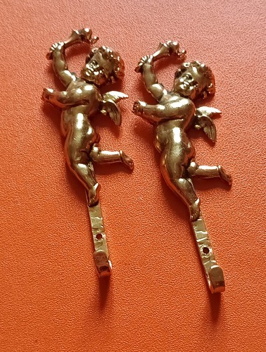 Pair brass angelots - of,