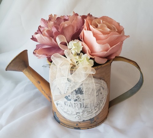 Watering can with flowers