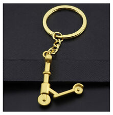 Porte-clés, bijou de sac trottinette en acier doré.