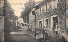 CPA 63 DORANGES ENTREE DU BOURG COTE SUD