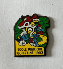 18 - Pin's ECOLE PUBLIQUE QUINZAINE 1993 - VILLAGE DES SCHTROUMPFS - SMURF