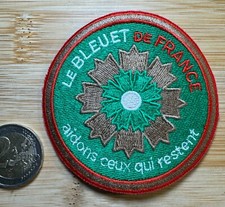 ECUSSON PATCH LE BLEUET DE FRANCE. AIDONS CEUX QUI RESTENT  (ÉCU 54) FONDS VERT