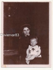 Vintage sepia photo motion blur - woman and baby moving his head