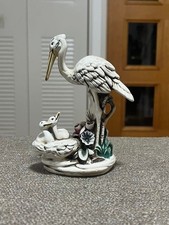 Figurine cigogne et enfant en