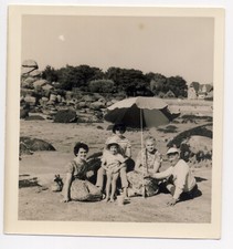 Vintage photo 1961 - 3 women, man, and girl on the beach under sun umbrella