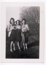 Vintage photo - 3 young women with flower bouquets outdoor